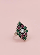 Decorative ring with gemstones on a pink background