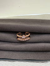 Rose gold ring with a diamond on a gray fabric background