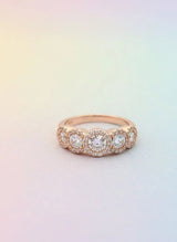 Rose gold ring with diamonds on a gradient background