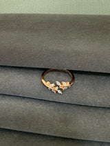 Gold ring with gemstones on a green fabric background