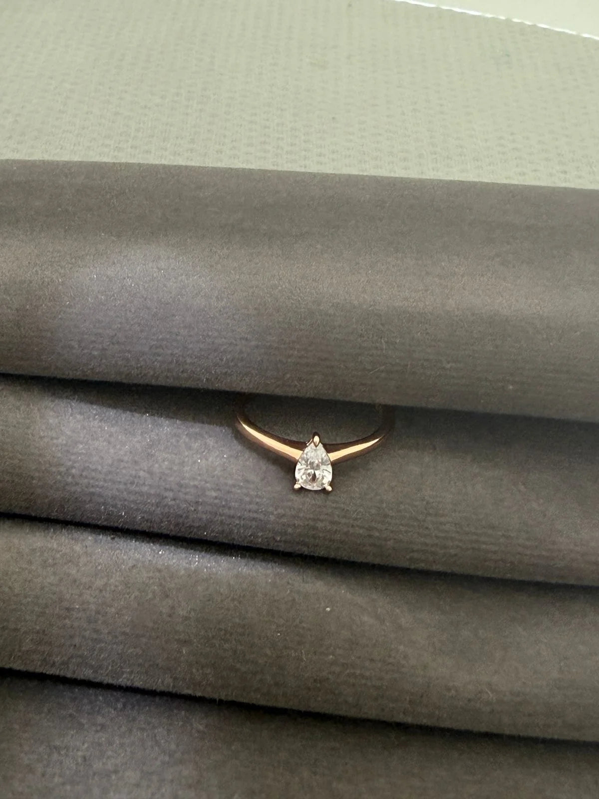 Diamond ring on a gray textured surface