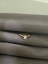 Diamond ring on a gray textured surface