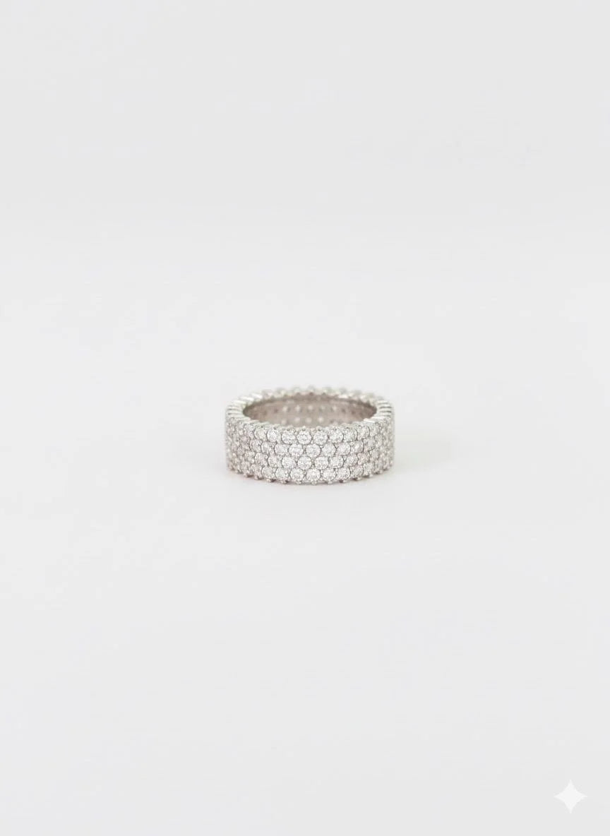 Silver ring with a textured band on a white background