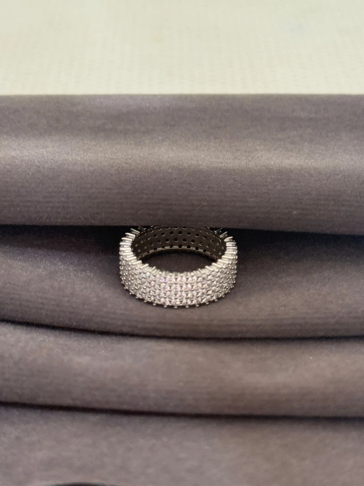 Silver beaded ring on a textured gray surface