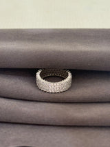 Silver beaded ring on a textured gray surface