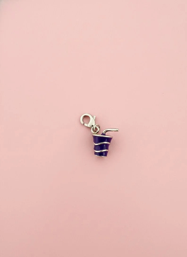 Cool drink charm with blue frosting on a pink background