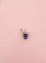 cool drink charm with blue frosting on a pink background