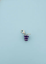 Small striped charm on a light blue background