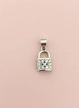 Silver padlock-shaped pendant with clear stones on a pink background