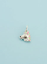 Unicorn-shaped charm on a light blue background