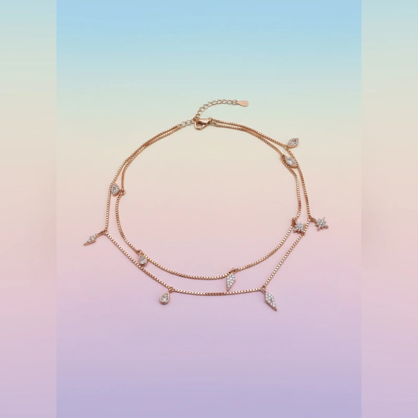 Rose gold anklet with small diamonds on a gradient background