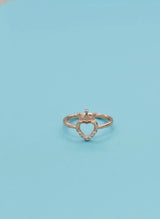 Heart-shaped ring with a crown on a light blue background