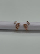 Rose gold toe rings on a white surface with a light gray background