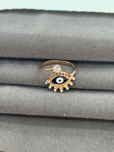 Ring with eye design on a gray fabric background
