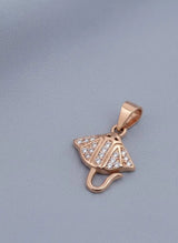 Rose gold pendant with diamond accents on a gray background