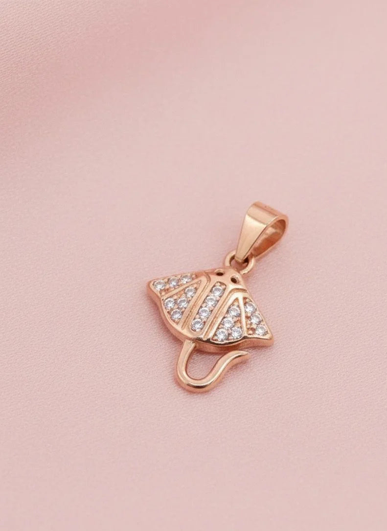Rose gold pendant with clear stones on a pink background