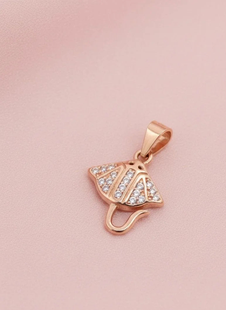 Rose gold pendant with clear stones on a pink background