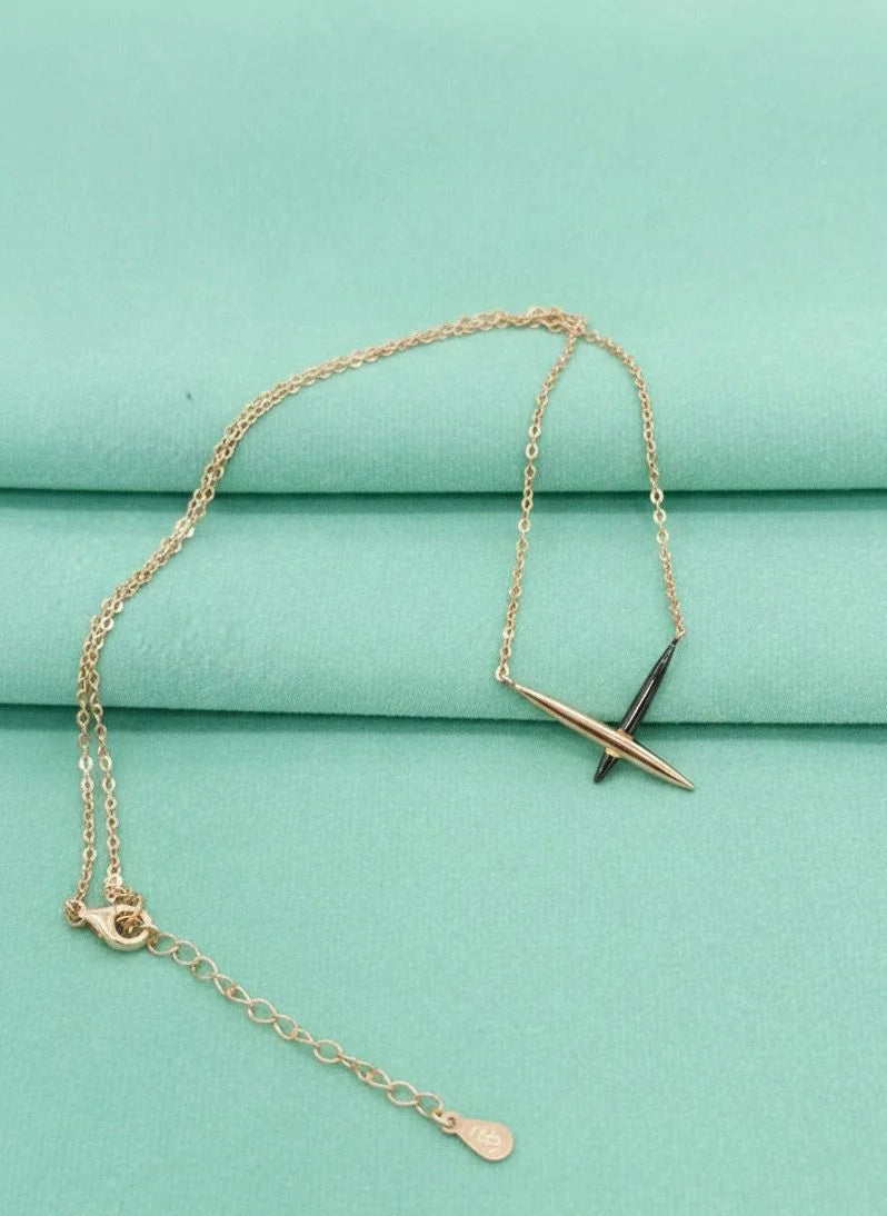 Rose gold necklace with a tiffany pendant on a teal fabric background
