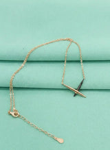 Rose gold necklace with a tiffany pendant on a teal fabric background