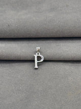 Silver 'P' pendant on a gray fabric background