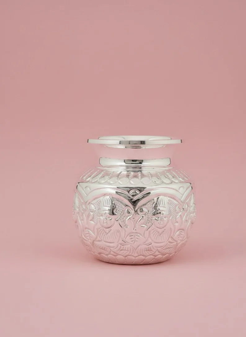 Decorative glass jar with silver lid on a pink background