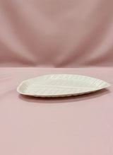 White ceramic plate on a pink background