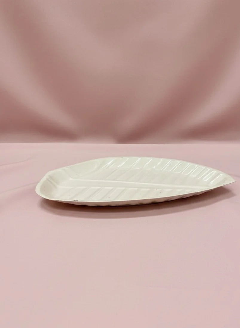 White ceramic plate on a pink background