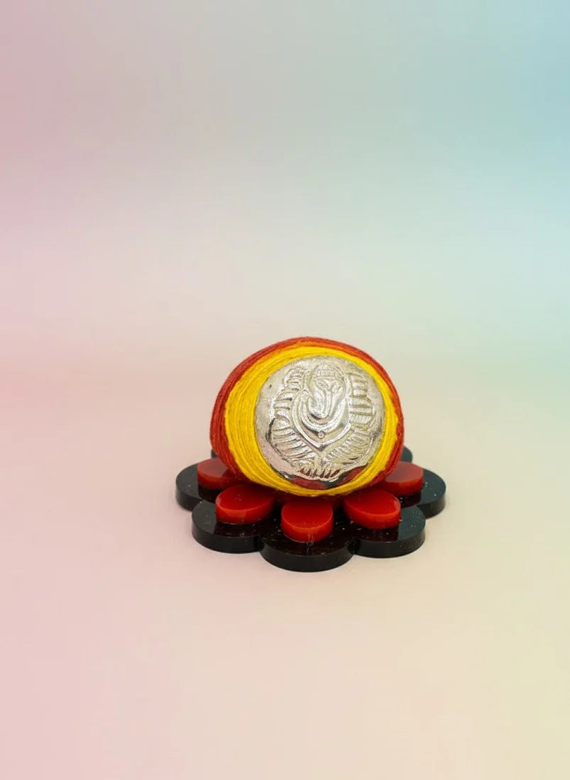 Decorative item with a central round object on a gradient background