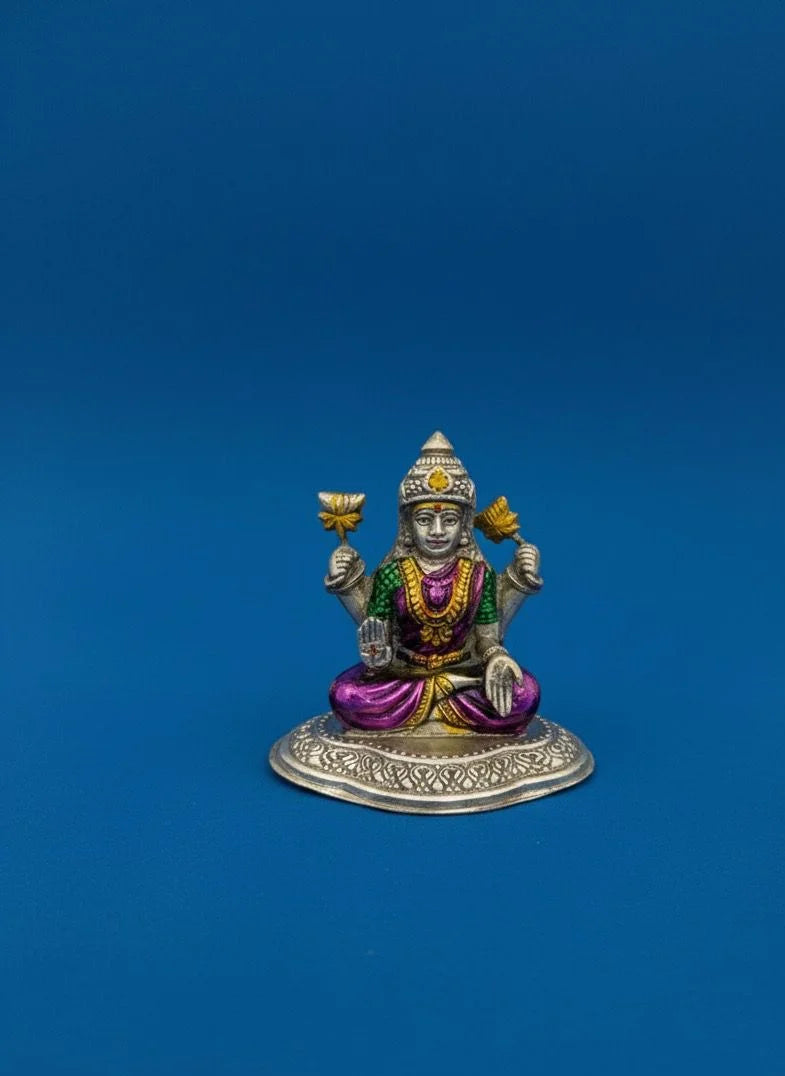 Decorative figurine of a seated figure with colorful attire on a blue background