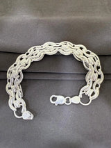 Silver chain bracelet on a gray background