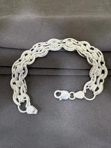 Silver chain bracelet on a gray background