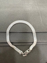 Silver bracelet on a gray surface