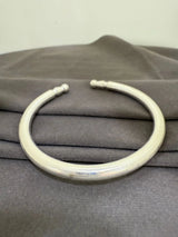 White neckpiece on a gray fabric background
