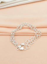 Silver chain bracelet on a beige fabric background