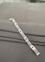 Silver bracelet on a gray surface
