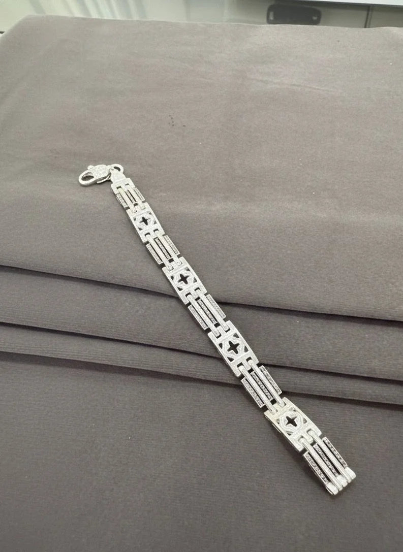 Silver bracelet on a gray surface