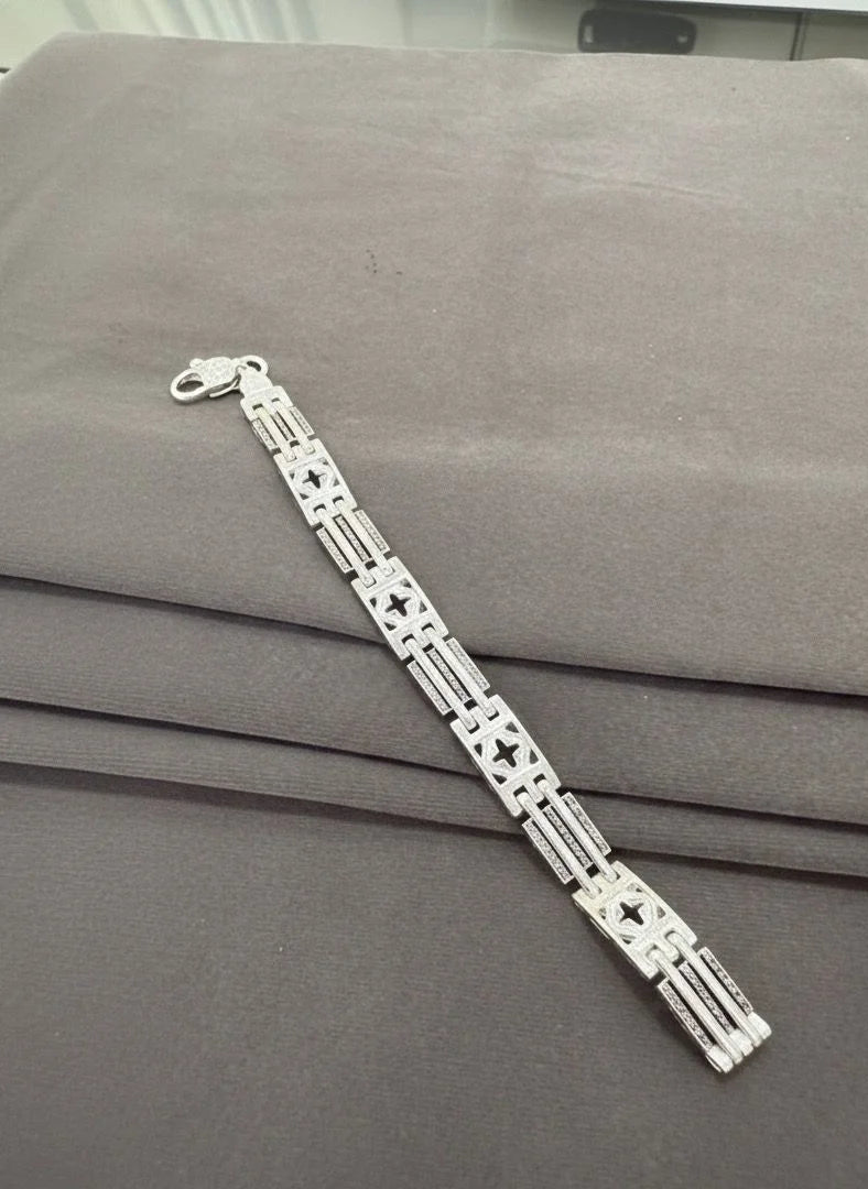 Silver bracelet on a gray surface