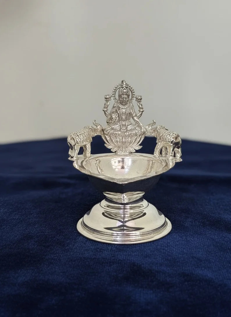 Silver decorative item on a blue fabric background