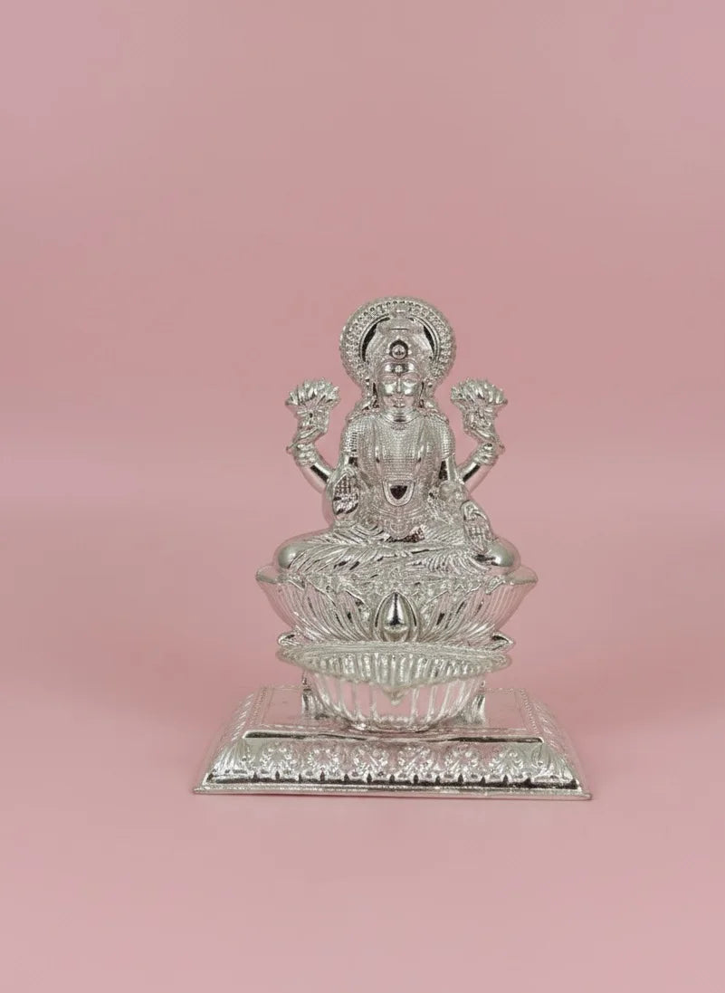 Silver statue on a pink background