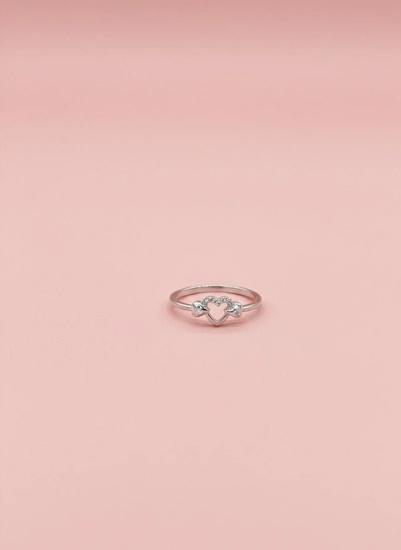 Rose gold ring with a diamond on a pink background