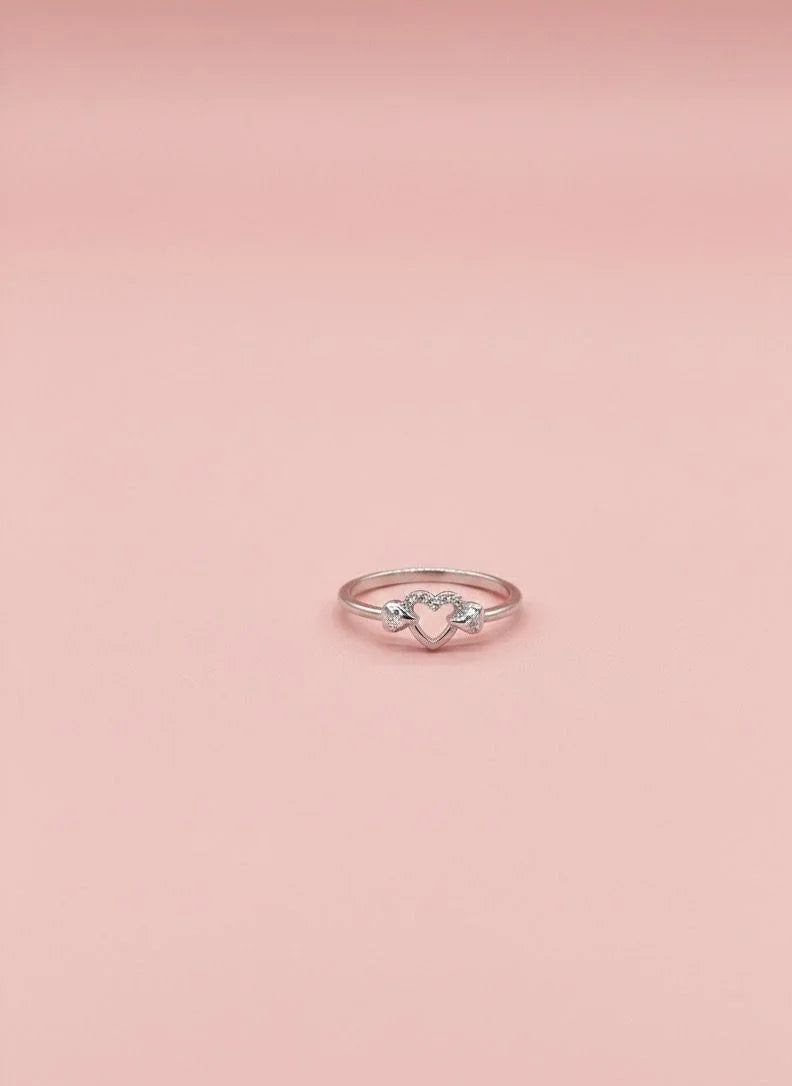 Rose gold ring with a diamond on a pink background