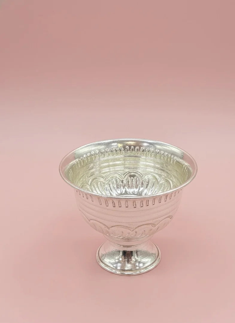 Silver goblet on a pink background