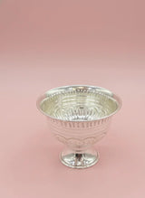 Silver goblet on a pink background