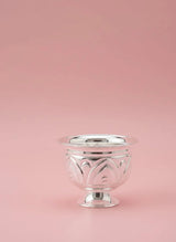 Silver decorative bowl on a pink background