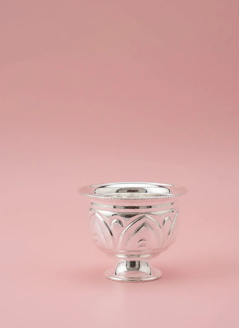 Silver decorative bowl on a pink background