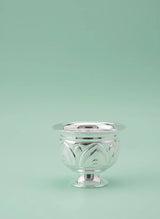 Silver decorative bowl on a light green background