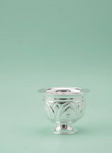 Silver decorative bowl on a light green background
