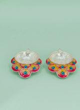 Pair of colorful earrings with a light green background