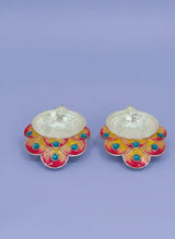 Pair of earrings with colorful floral designs on a light purple background