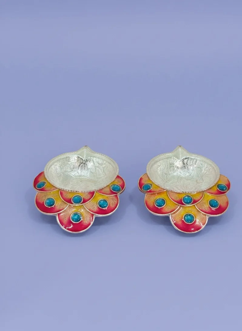 Pair of earrings with colorful floral designs on a light purple background